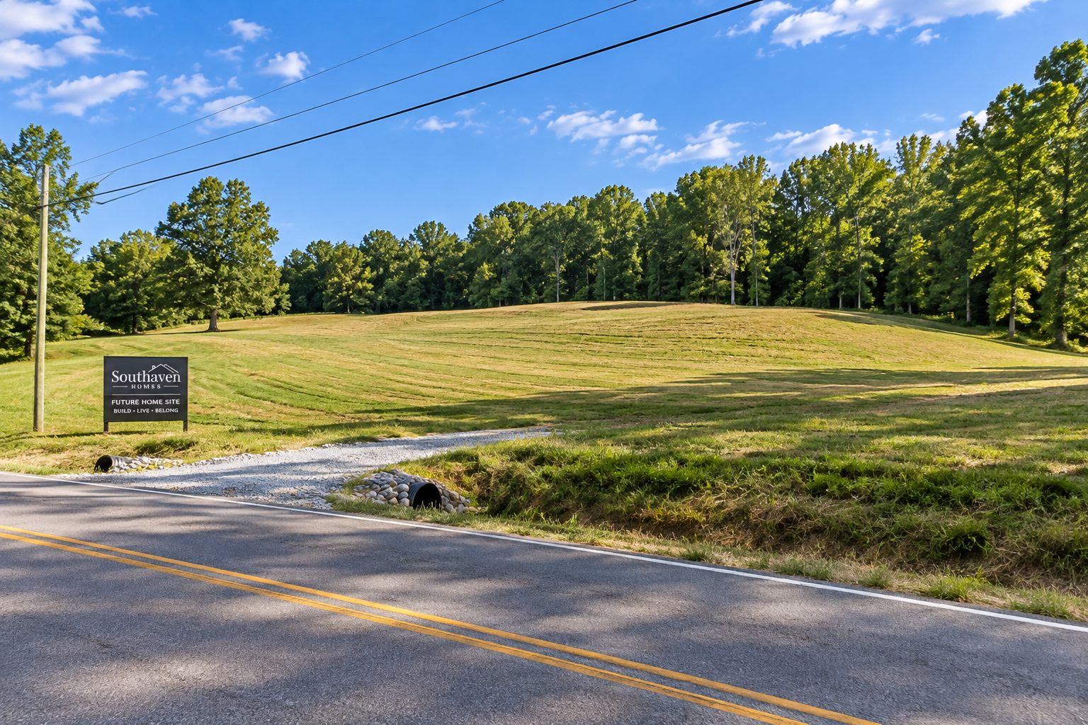 Wide daylight shot of an open Dickson County home site before construction