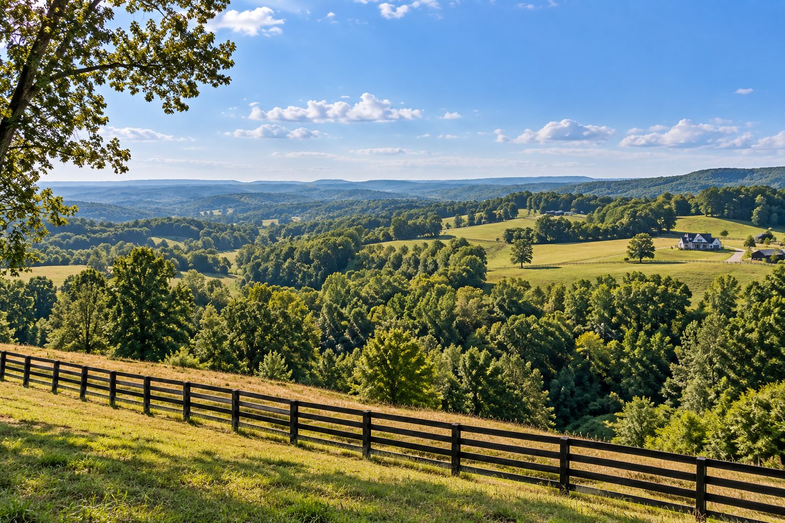 Long view down a Middle Tennessee ridge line in daylight - rolling fields, fence line